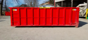 a red dumpster with a yellow sign that says maximum loading level